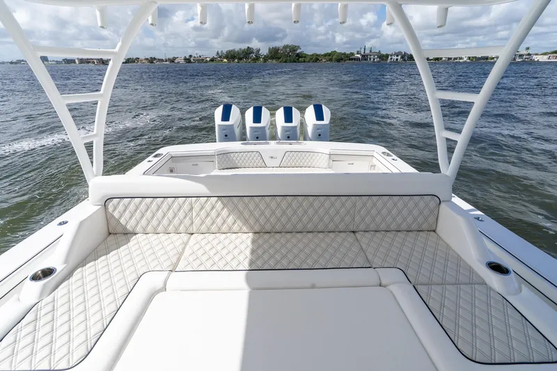 Slide: The Image of 2025 Valhalla Boatworks V-55 luxury deck with triple outboard engines on open water. - 35