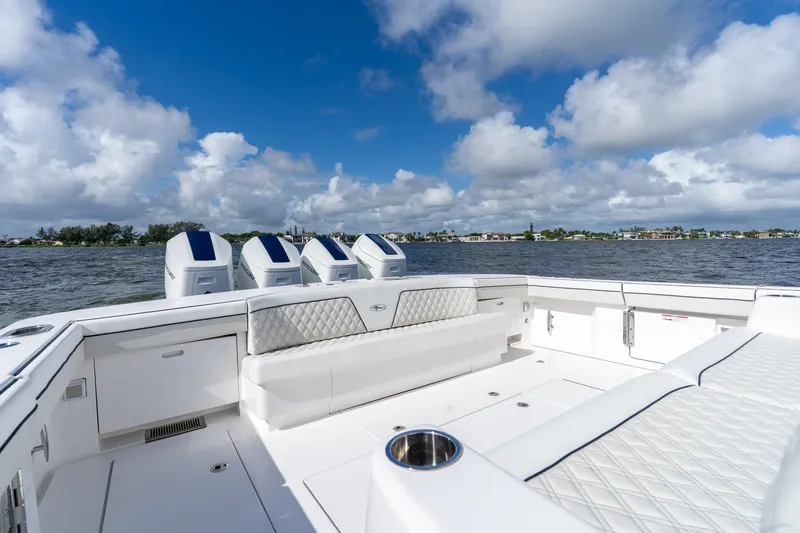 Slide: The Image of 2025 Valhalla Boatworks V-55, luxurious deck view, four powerful engines, scenic water backdrop. - 38