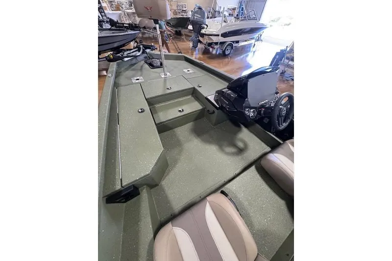 Slide: The Image of 2026 Vexus AVX181 DEFENDER boat interior with steering console and seating. - 11