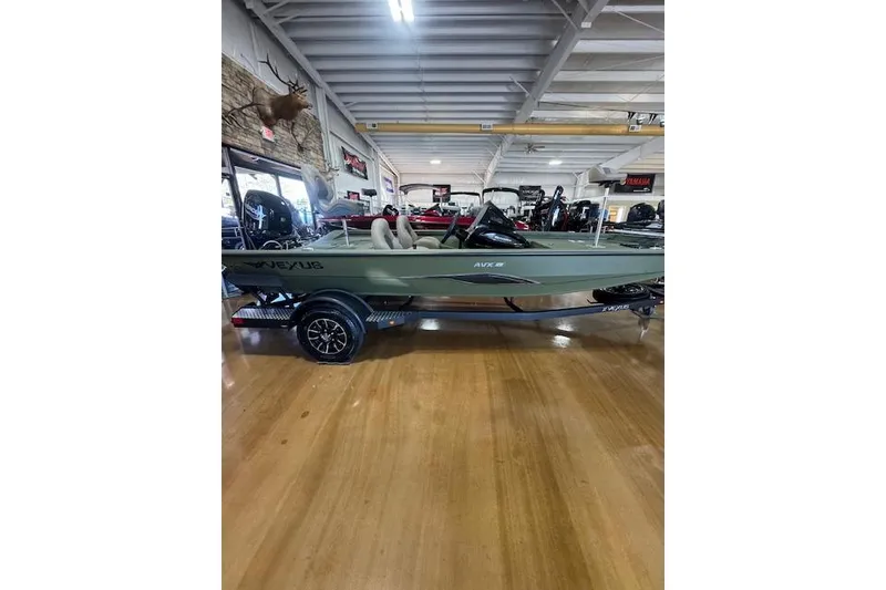 Slide: The Image of 2026 Vexus AVX181 DEFENDER boat displayed indoors on a trailer. - 2