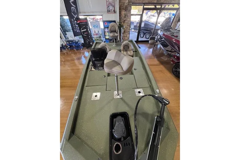 Slide: The Image of 2026 Vexus AVX181 DEFENDER boat interior with seating and control panel in showroom. - 6