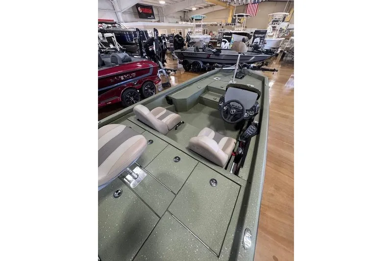 Slide: The Image of 2026 Vexus AVX181 DEFENDER boat interior with dual seats and steering console in showroom. - 8