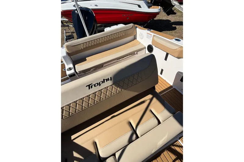 Slide: The Image of 2026 Trophy T22SC boat interior with beige seating and wood accents. - 14