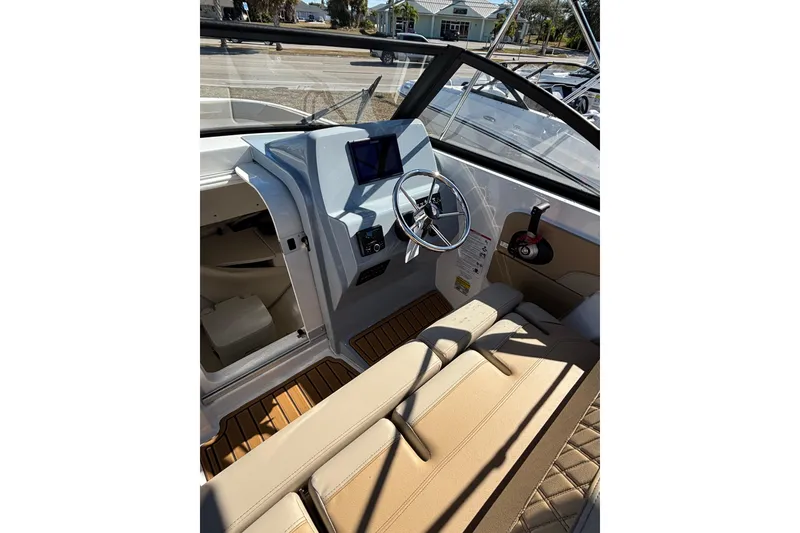 Slide: The Image of Interior of 2026 Trophy T22SC boat with steering wheel and beige seating. - 9