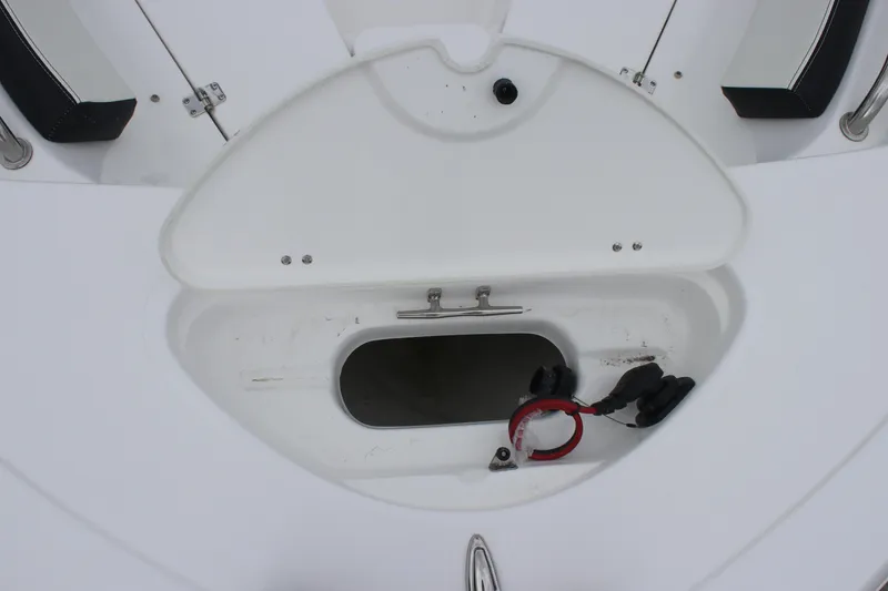 Slide: The Image of 2026 Tidewater 198 CC Adventure boat livewell with white seating and blue interior. - 10