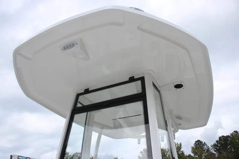 Slide: The Image of 2026 Tidewater 198 CC Adventure boat with white cushioned seating and stainless steel rail. - 14