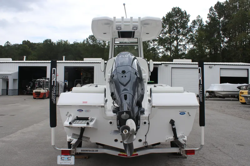 Slide: The Image of 2026 Tidewater 198 CC Adventure boat seats with black and white upholstery, docked near other boats. - 7