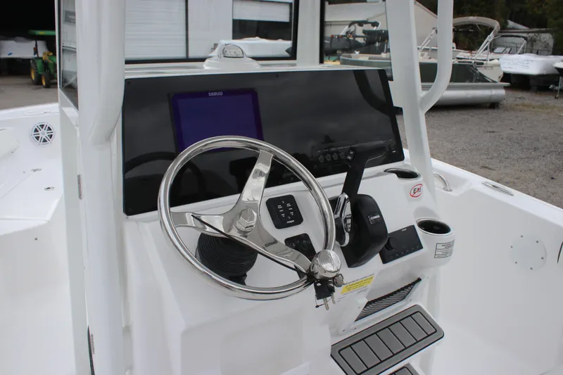 Slide: The Image of 2026 Tidewater 198 CC Adventure boat with open storage compartment and seating. - 9