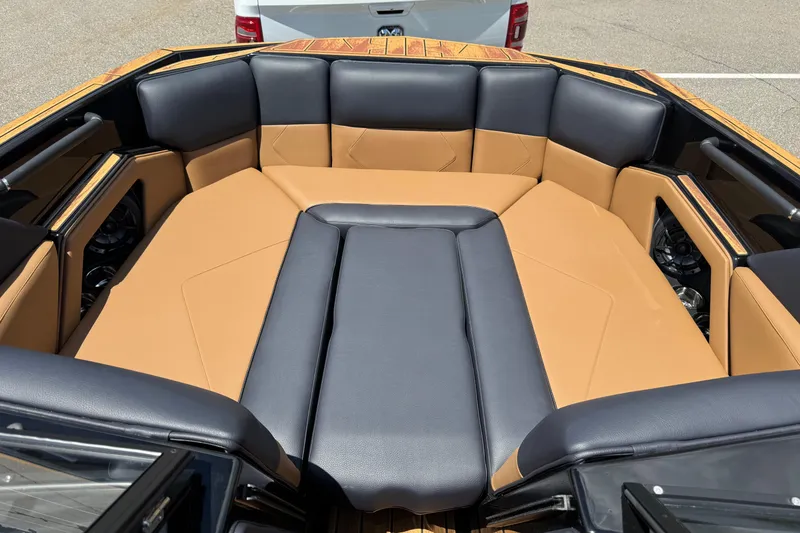 Slide: The Image of 2025 Moomba Tykon boat interior with tan and black seating. - 8