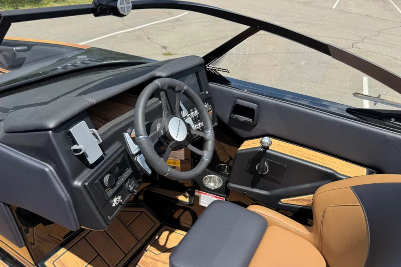 Slide: The Image of 2025 Moomba Tykon boat interior with steering wheel and control panel. - 9