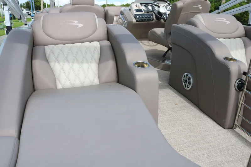 Slide: The Image of 2018 Bennington 23 QCW boat interior with luxurious seating and modern dashboard. - 12