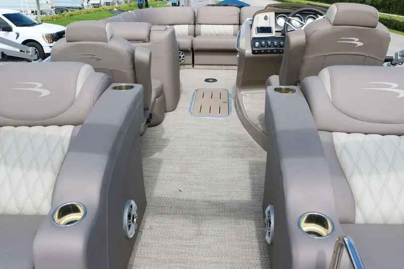 Slide: The Image of 2018 Bennington 23 QCW pontoon boat interior with luxurious seating and modern dashboard. - 13