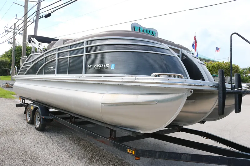 Slide: The Image of 2018 Bennington 23 QCW pontoon boat on trailer, parked outdoors. - 3