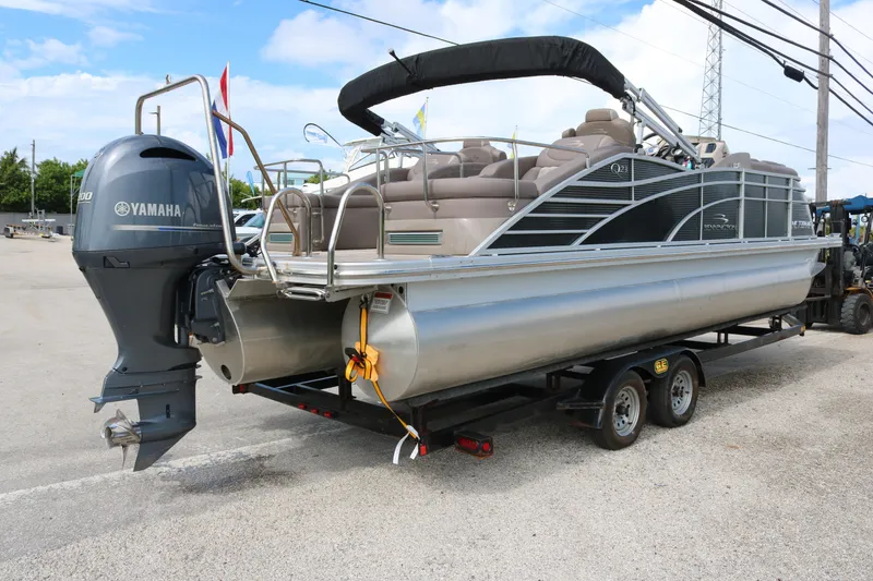 Slide: The Image of 2018 Bennington 23 QCW pontoon boat with Yamaha engine on trailer. - 4