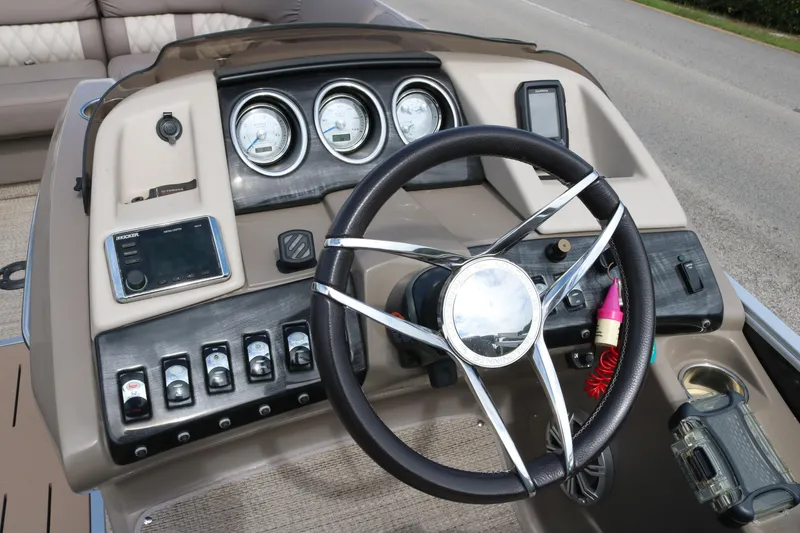 Slide: The Image of 2018 Bennington 23 QCW boat dashboard with steering wheel and control panel. - 6