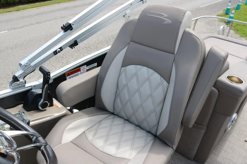 Slide: The Image of Luxurious seating on 2018 Bennington 23 QCW boat, featuring diamond-stitched upholstery and armrest. - 7