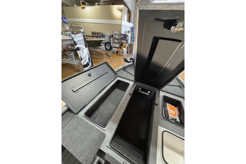 Slide: The Image of 2026 Vexus AVX 1980 boat interior storage compartments in showroom display. - 18