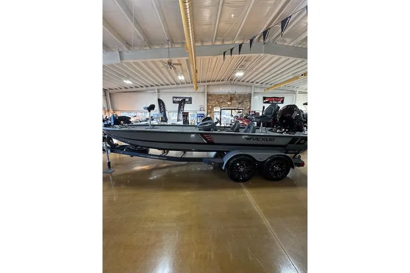 Slide: The Image of 2026 Vexus AVX 1980 boat displayed indoors on a trailer. - 2