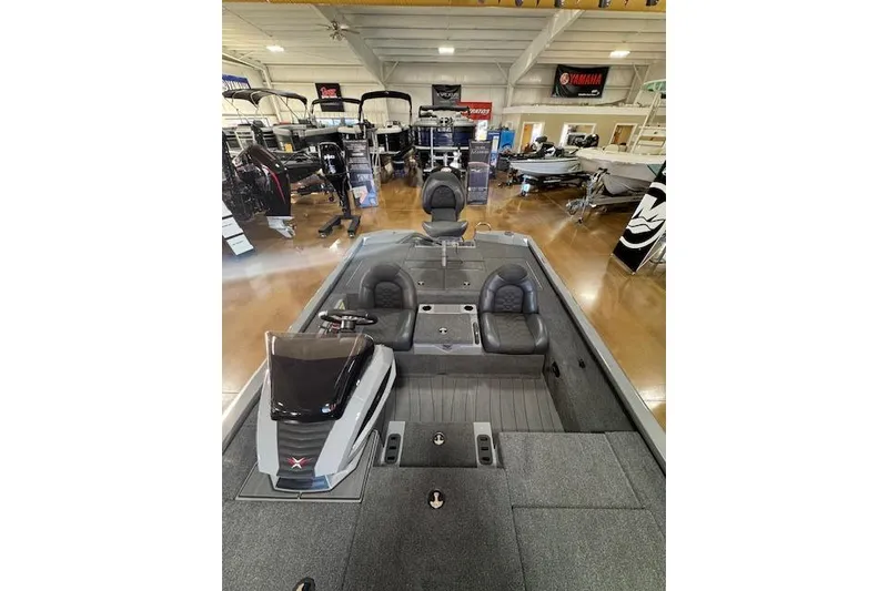 Slide: The Image of 2026 Vexus AVX 1980 boat interior in showroom, featuring seating and control console. - 7