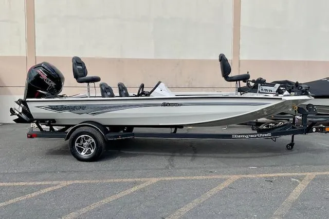 The Image of 2026 Ranger RT188P fishing boat on trailer, side view, parked outdoors. - 0