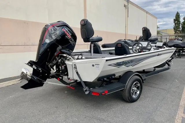 Slide: The Image of 2026 Ranger RT188P boat with outboard motor on trailer, parked outdoors. - 10