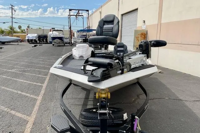 Slide: The Image of 2026 Ranger RT188P fishing boat parked outdoors near a warehouse. - 6