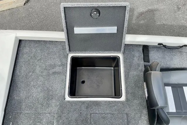 Slide: The Image of 2026 Ranger RT188P boat storage compartment with open lid and adjacent seat. - 7