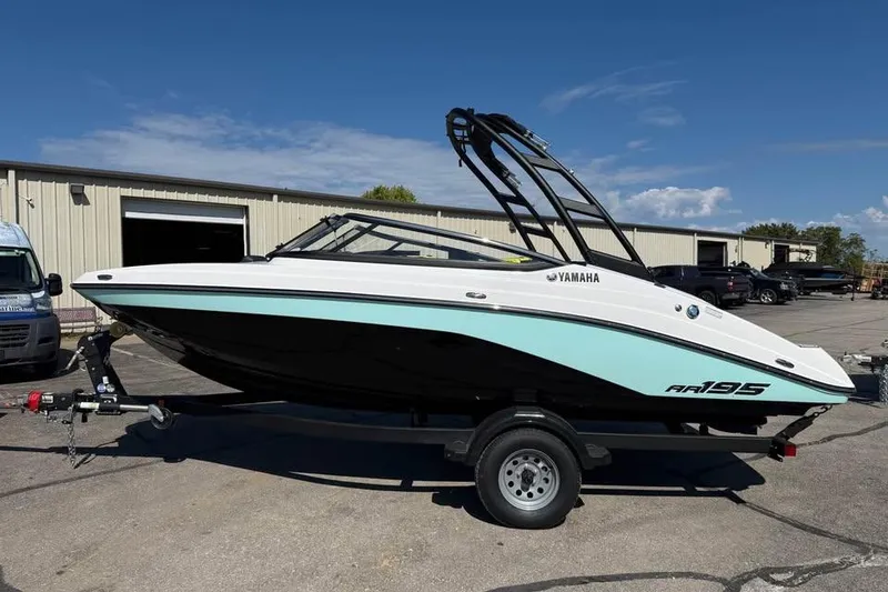 The Image of 2026 Yamaha Boats AR195 on trailer, parked outdoors under clear sky. - 0