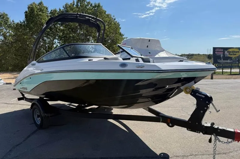 Slide: The Image of 2026 Yamaha Boats AR195 on trailer, sleek design, parked outdoors. - 3