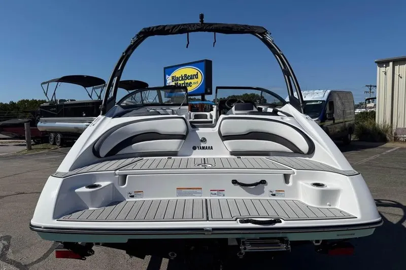 Slide: The Image of 2026 Yamaha Boats AR195 at BlackBeard Marine, rear view with seating and swim platform. - 5