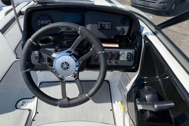 Slide: The Image of 2026 Yamaha Boats AR195 steering wheel and dashboard controls. - 8