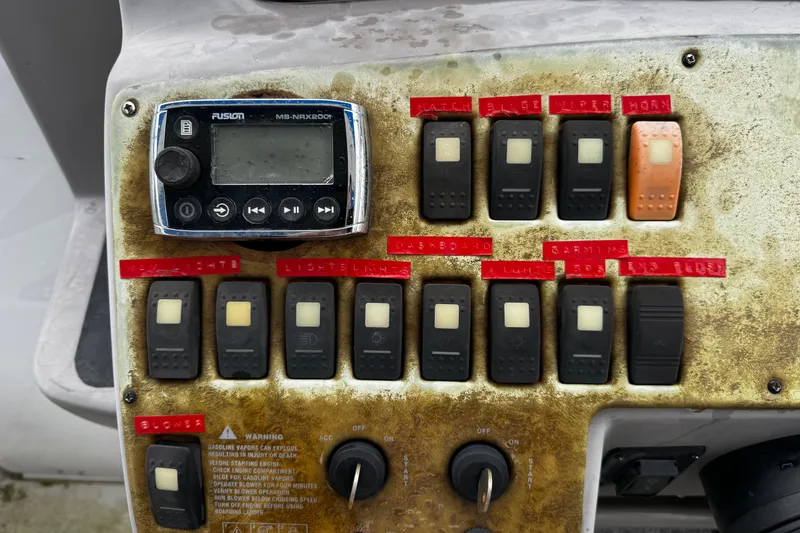 Slide: The Image of Control panel of a 2007 Rinker 300 Fiesta Vee boat with switches and stereo system. - 11