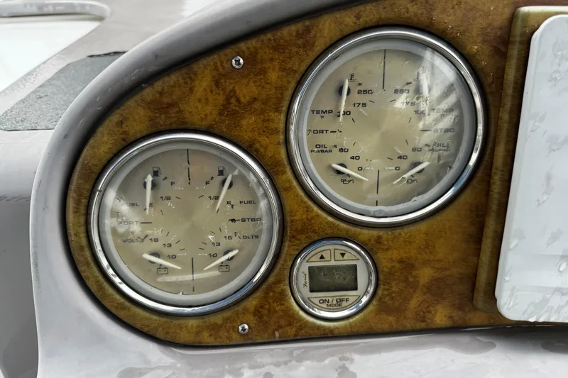 Slide: The Image of Dashboard gauges of a 2007 Rinker 300 Fiesta Vee boat. - 12