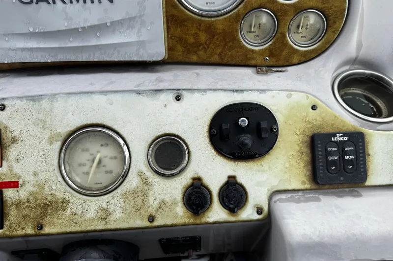 Slide: The Image of Control panel of a 2007 Rinker 300 Fiesta Vee boat with gauges and switches. - 13