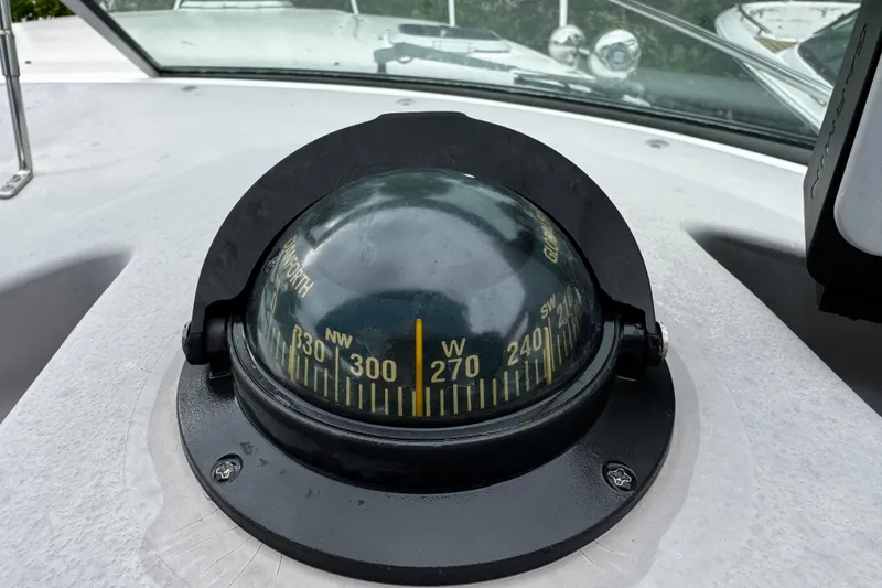 Slide: The Image of Compass on 2007 Rinker 300 Fiesta Vee boat dashboard, showing northwest direction. - 17