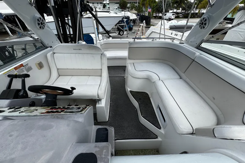 Slide: The Image of 2007 Rinker 300 Fiesta Vee boat interior with white seating and steering area. - 19