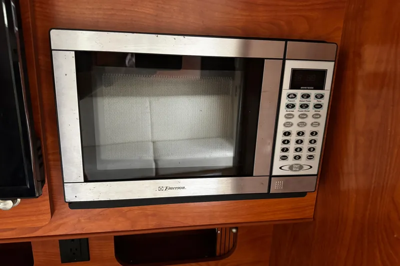 Slide: The Image of Emerson microwave in 2007 Rinker 300 Fiesta Vee boat kitchen. - 24