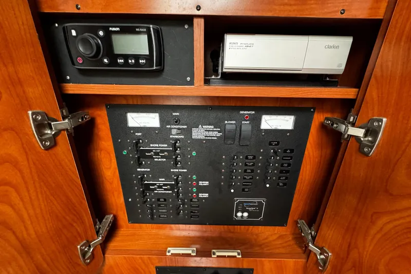 Slide: The Image of Control panel inside 2007 Rinker 300 Fiesta Vee boat, featuring audio and power systems. - 27