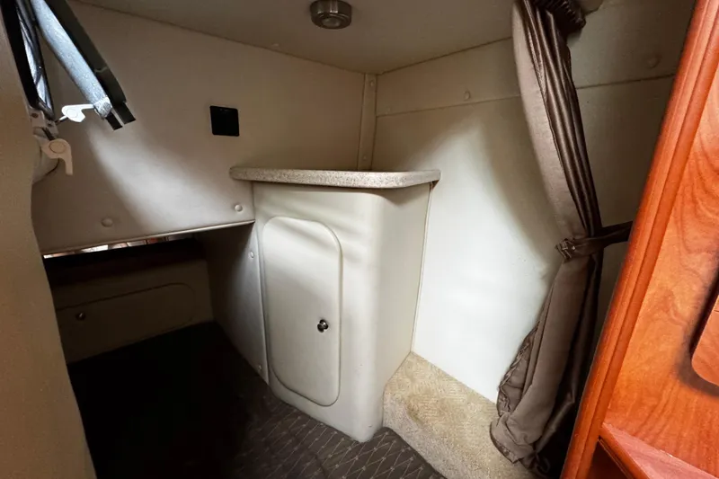 Slide: The Image of Interior cabin of 2007 Rinker 300 Fiesta Vee boat, featuring storage and curtain. - 28