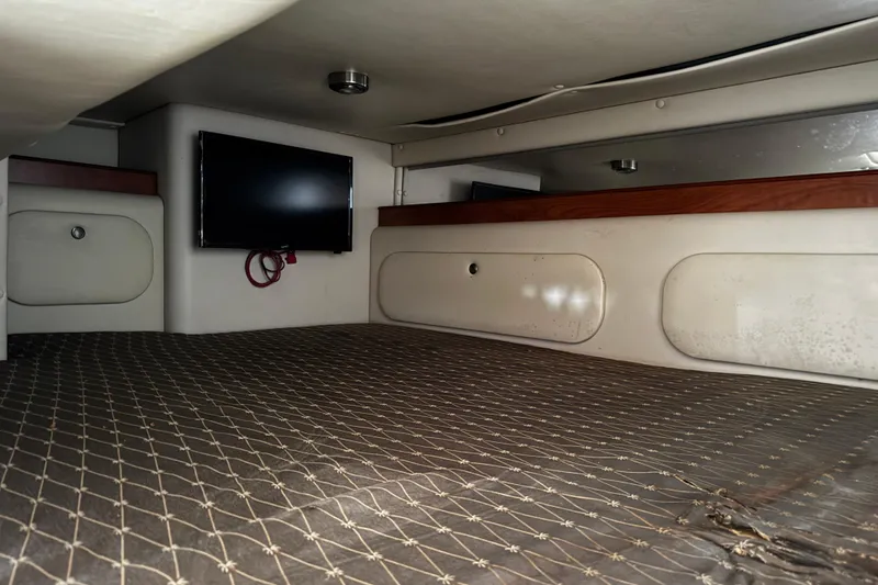 Slide: The Image of 2007 Rinker 300 Fiesta Vee cabin interior with TV and bed. - 29