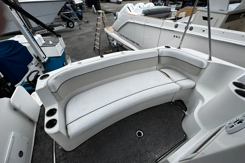 Slide: The Image of 2007 Rinker 300 Fiesta Vee boat interior with white seating and cup holders. - 3