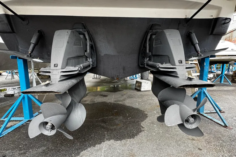 Slide: The Image of 2007 Rinker 300 Fiesta Vee boat propellers on stands, showcasing dual outdrives. - 31