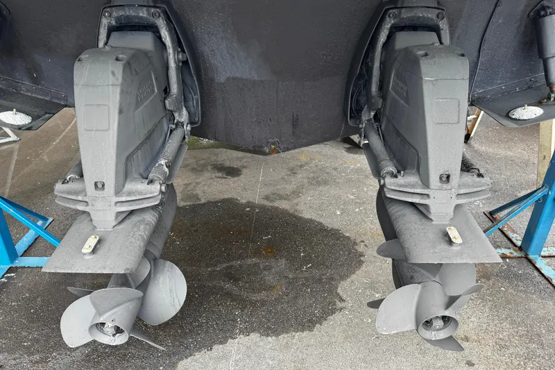 Slide: The Image of 2007 Rinker 300 Fiesta Vee boat propellers and outdrives on a stand. - 32