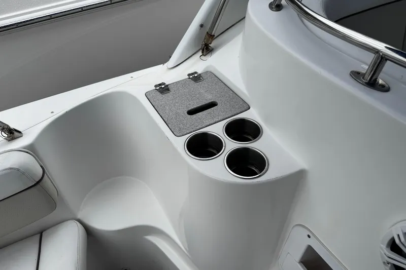 Slide: The Image of 2007 Rinker 300 Fiesta Vee boat interior with cup holders and storage compartment. - 4