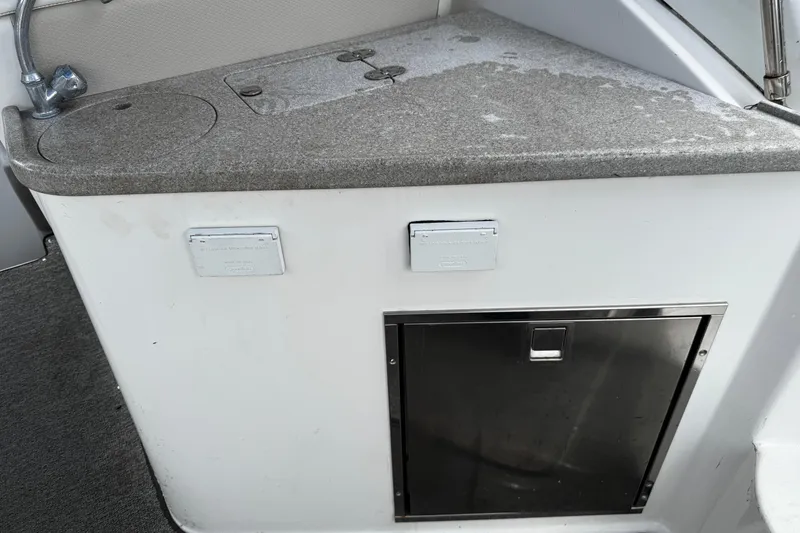Slide: The Image of 2007 Rinker 300 Fiesta Vee boat kitchenette with sink and storage. - 5