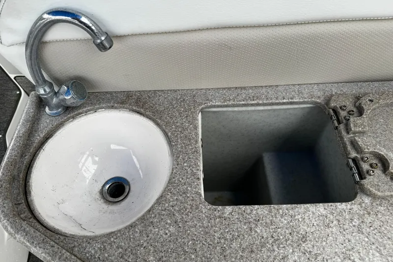 Slide: The Image of 2007 Rinker 300 Fiesta Vee boat sink and storage compartment. - 6