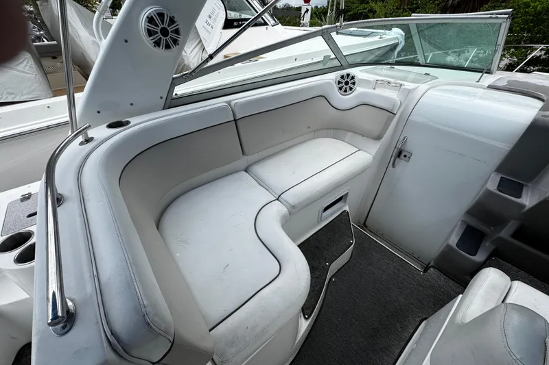 Slide: The Image of 2007 Rinker 300 Fiesta Vee boat interior with white seating and speaker. - 7