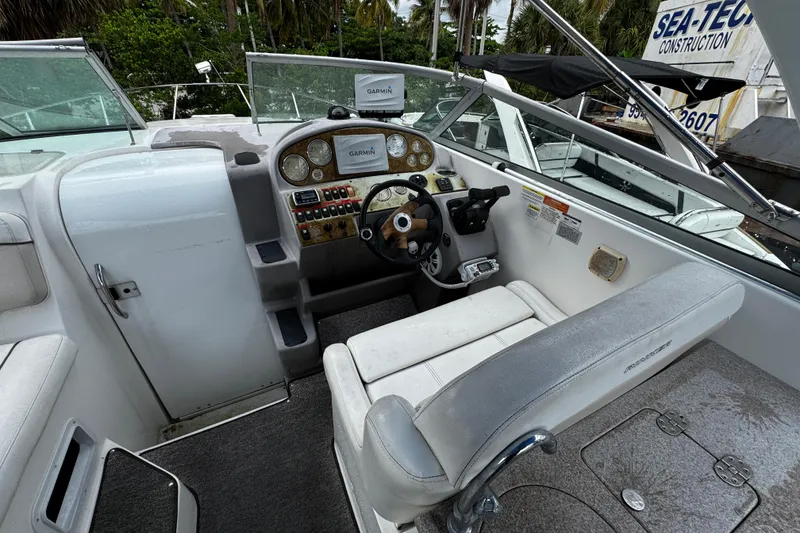Slide: The Image of 2007 Rinker 300 Fiesta Vee boat cockpit with steering wheel and Garmin navigation system. - 8