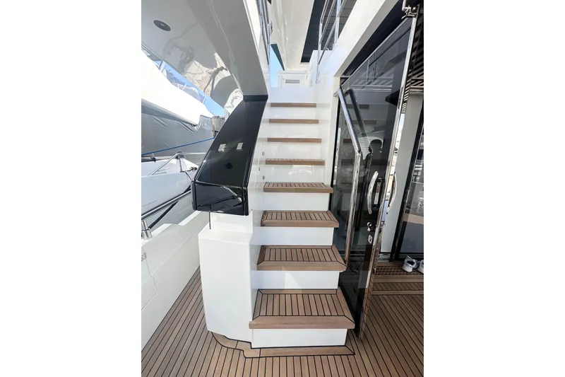 Slide: The Image of Staircase on 2026 Astondoa 66 Fly yacht with sleek design and wooden steps. - 10