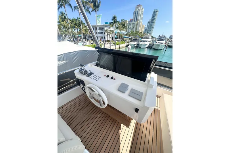 Slide: The Image of Helm of 2026 Astondoa 66 Fly yacht with modern controls and waterfront view. - 12